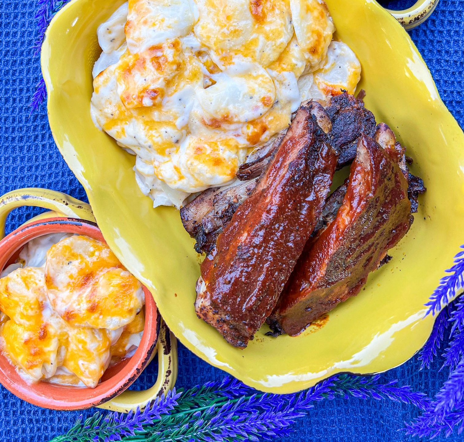 Main St Bistro scalloped potatoes in a casserole dish with bbq ribs